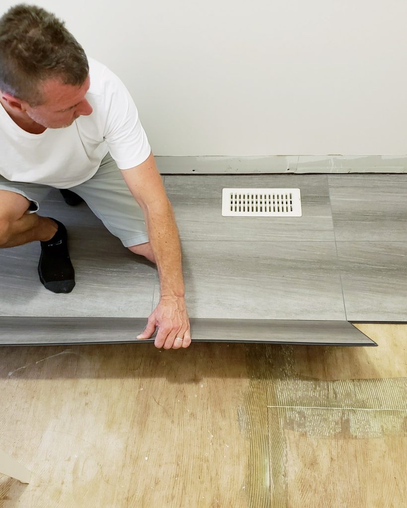 flooring-installation-updating-floor-to-new-laminate-clipboard-that-looks-like-ceramic-tiles.jpg
